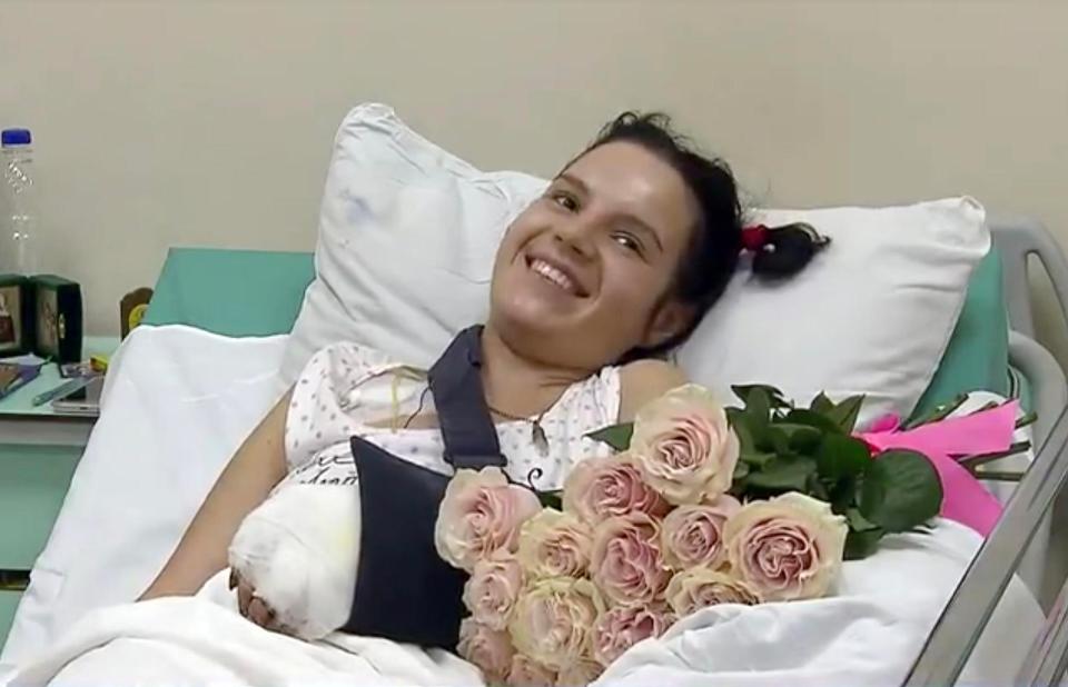  Axe attack victim Margarita Grachyova smiles bravely in hospital after jealous husband hacked off her hands