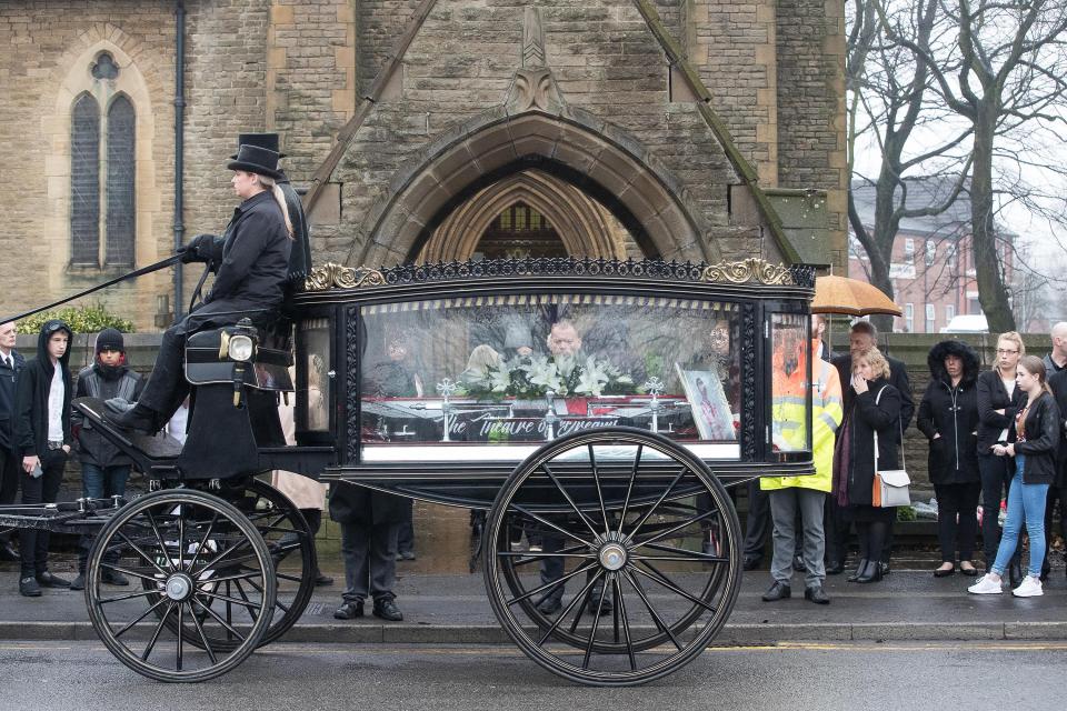  A carriage carrying the coffin outside the church in Denton, Gtr Manchester