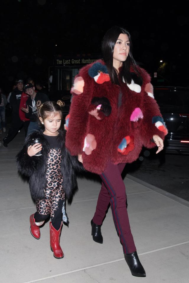  Kourtney was certainly not going to get chilly in the large festive coat