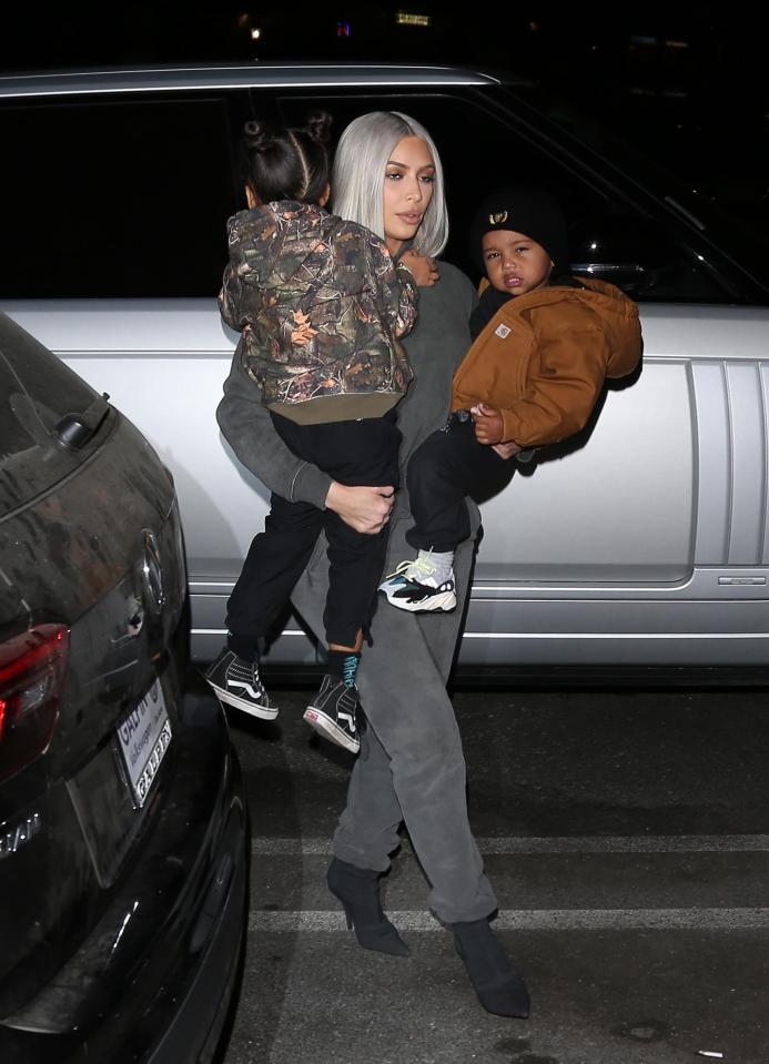  Kim scooped up her kids as they made their way to the ice rink