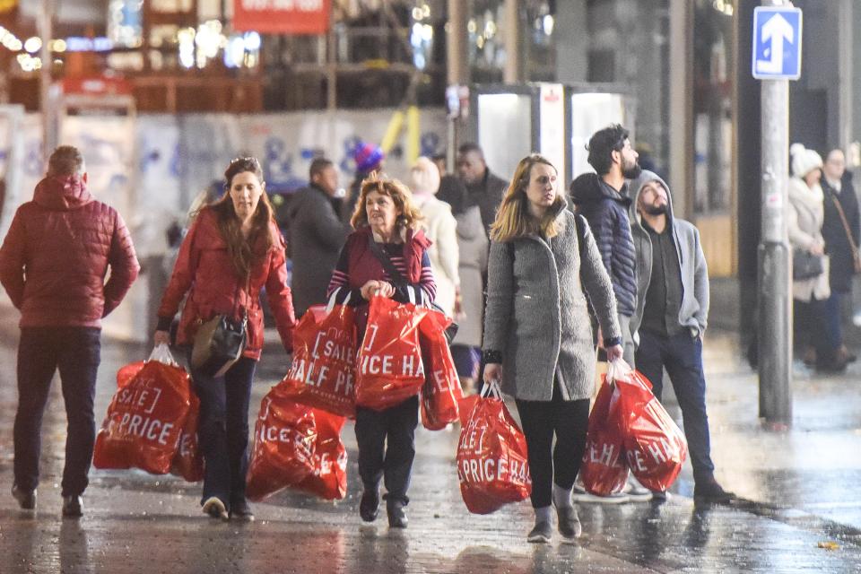  Ladies laden with bags after hitting the sales at 6am