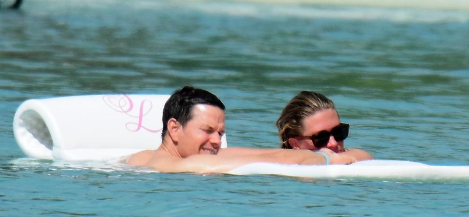  Mark floats on a lilo with wife Rhea