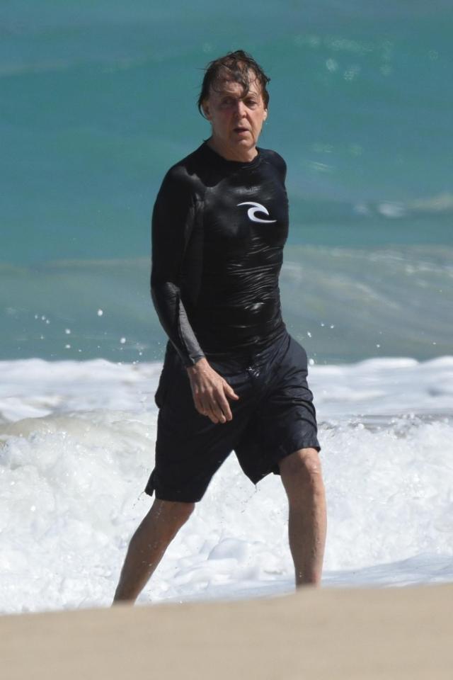  Sir Paul pulled on a wetsuit top and swimshorts for his beach visit