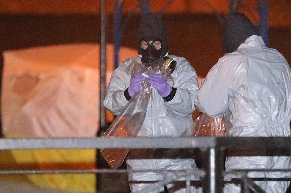  Police officers in forensics suits and protective masks work at the scene of the poisoning of Sergei Skripal yesterday