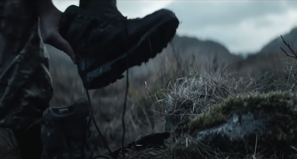 The soldier can be seen removing his helmet, boots and weapon as he starts to pray