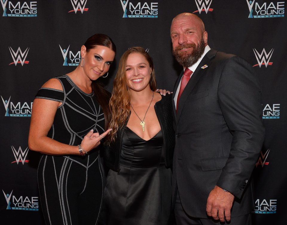  Ronda Rousey with WWE chief Triple H and Stephanie McMahon ahead of her expected debut