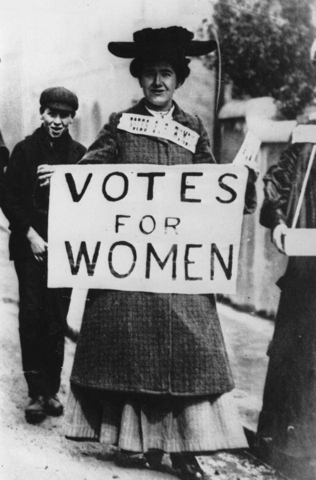  Tess Billington carries a banner inscribed with the suffragette slogan 'Votes For Women' during a demonstration in the Ladies Gallery in the House of Commons, London