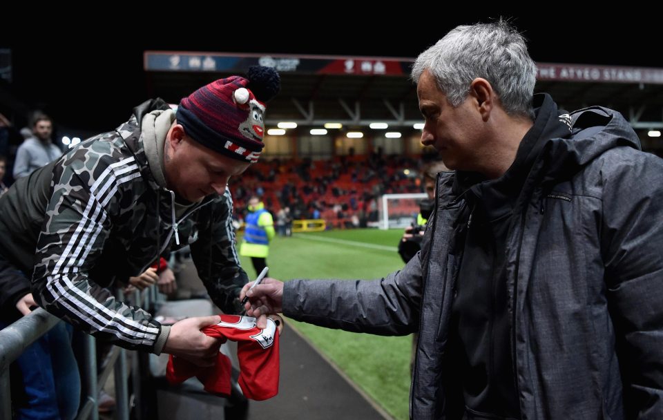  Jose Mourinho signs a fan's shirt before Manchester United's loss to Bristol City