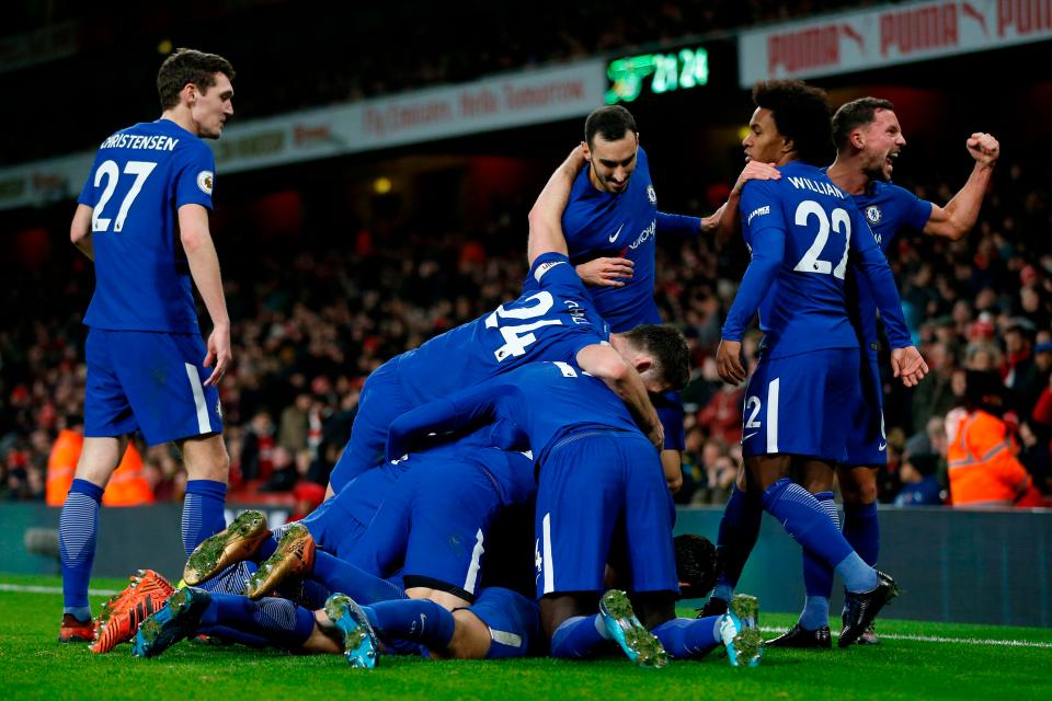  Chelsea footballers celebrate a goal against Arsenal in a recent match