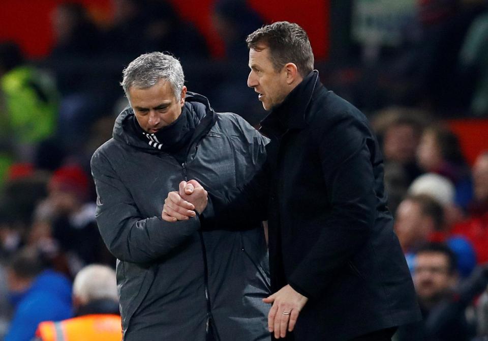  Two managers shake hands after a 90 minute battle at Old Trafford