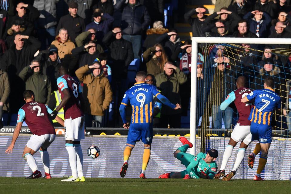 Hart dives low to his left to deny the Shrews as West Ham limped to a goalless draw