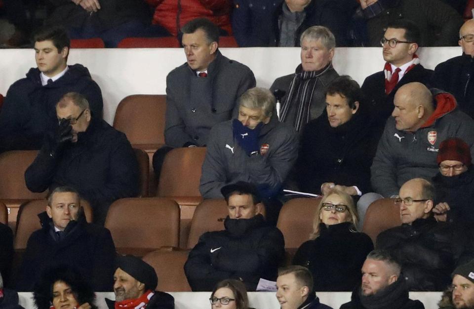 Wenger sat with his head in his hands after his side crashed out of FA Cup 