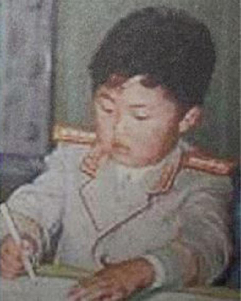  The youngster is seen dressed in a formal military outfit while drawing