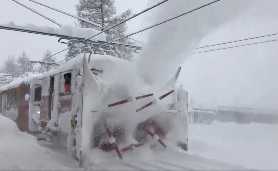  A train clears snow from a railway in the Zermatt resort