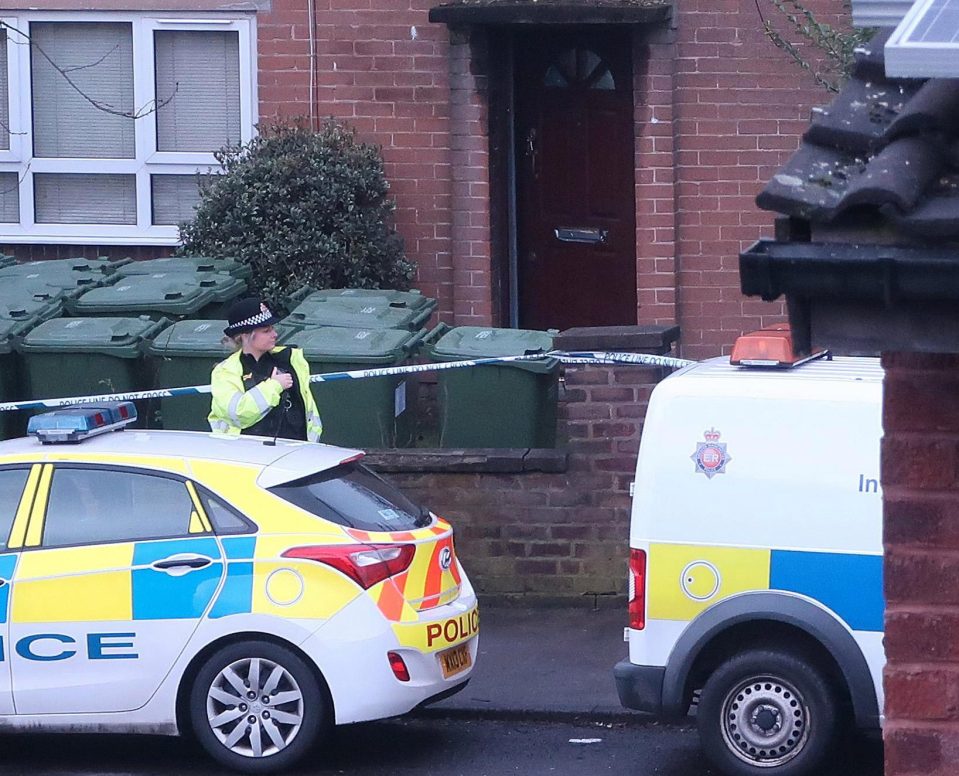  A police officer stands outside the home that was searched