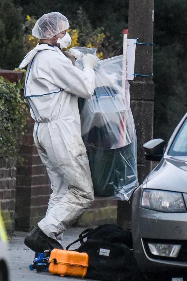  Forensic officers take away bags of evidence from the home in Reddish as part of their investigation