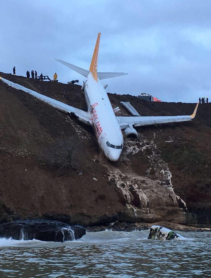 A Pegasus airplane is seen stuck in mud as it skidded off the runway after landing in Trabzon Airport, Turkey