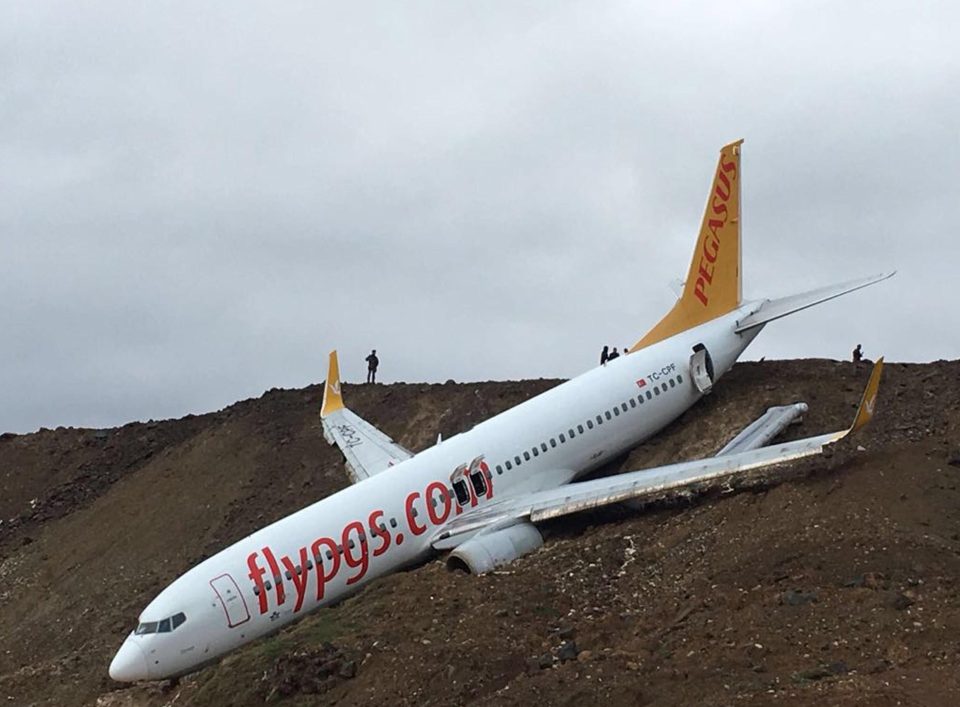 The Pegasus Airlines Boing 737 passenger plane is seen struck in mud on an embankment