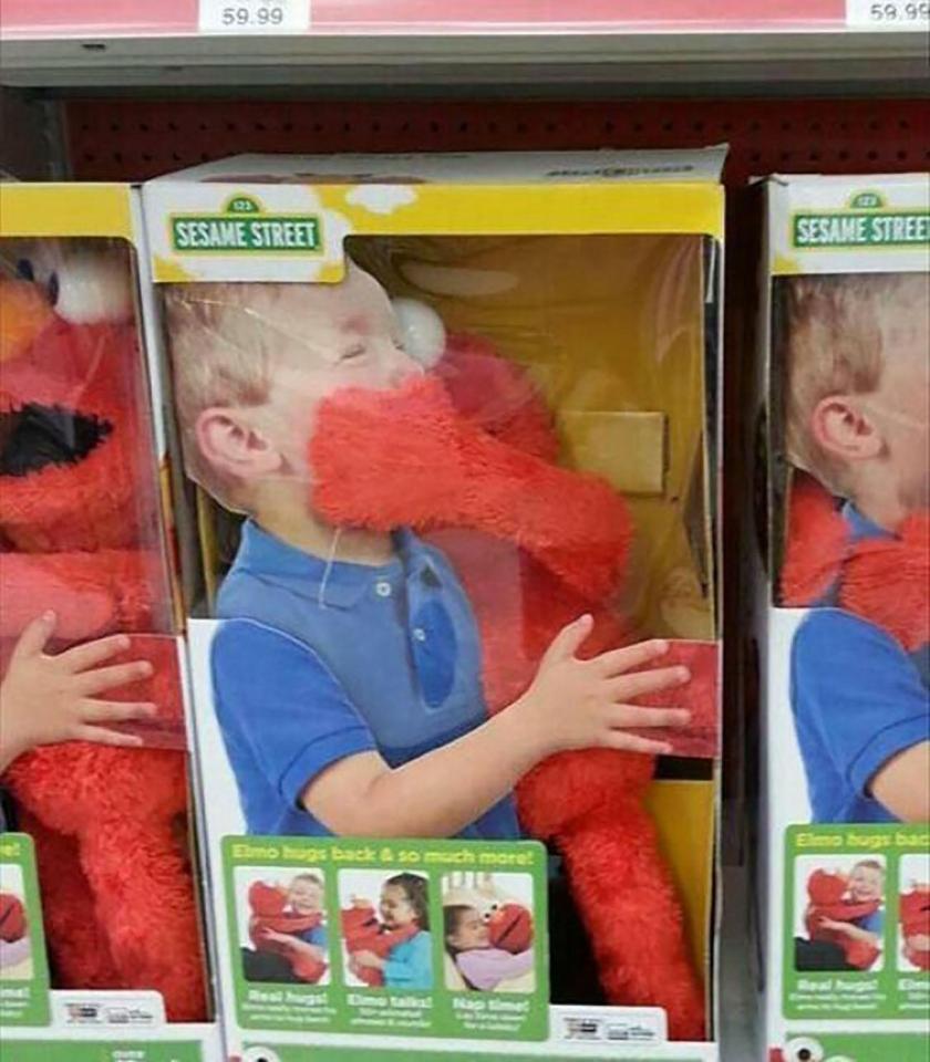  The child doesn't appear to be enjoying this Elmo who 'hugs back'