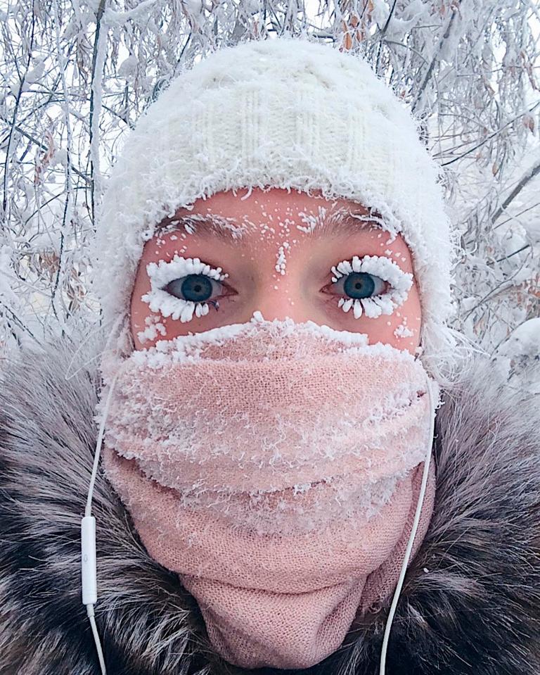  A woman takes a selfie photograph after her eyelashes turned into icicles