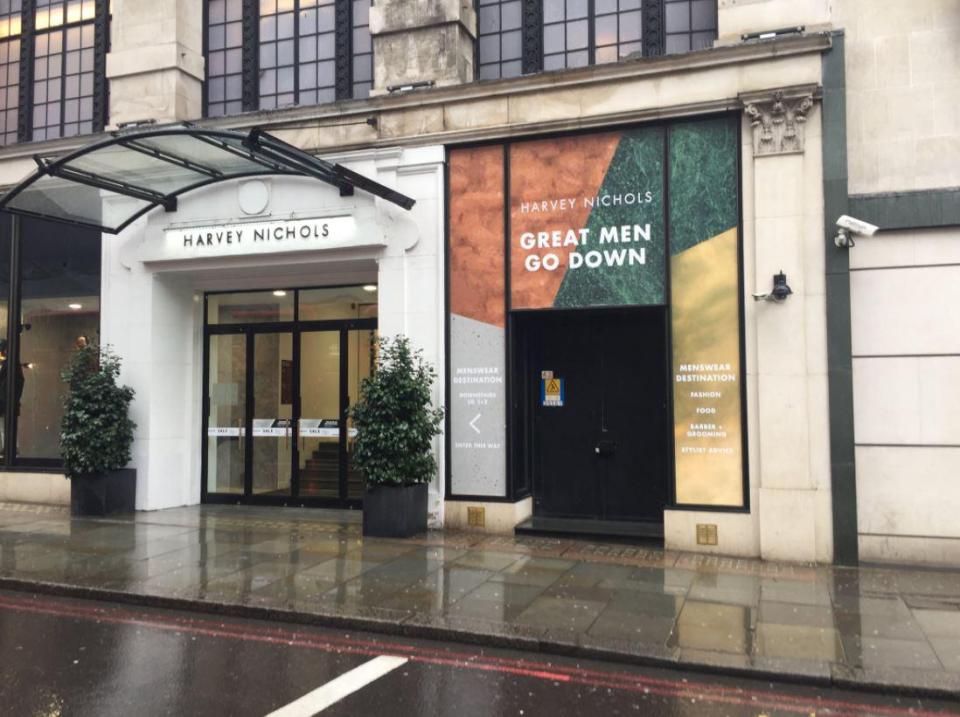  A sign outside Harvey Nichols in London says "Great men go down"