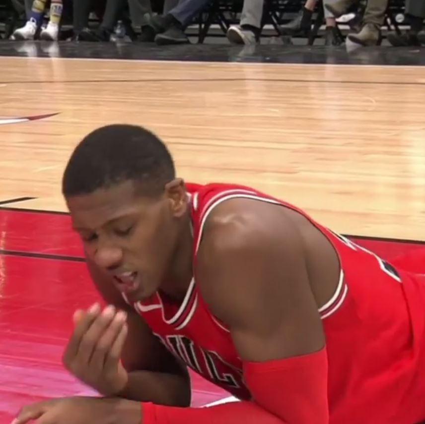 Kris Dunn checks his mouth for blood after landing on his face