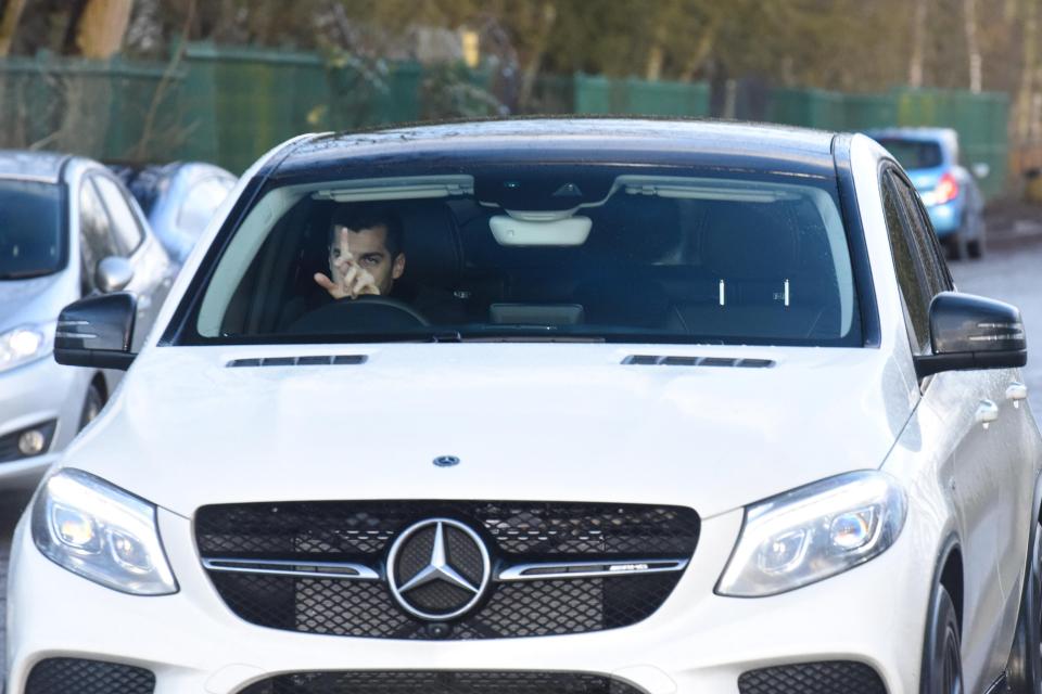  The Armenian gestured to photographers as he drove his white Mercedes to Manchester United's training ground at Carrington