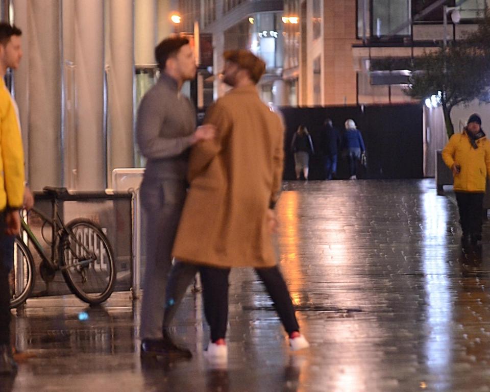  Security guards watched on as the pair spoke on the street in Manchester