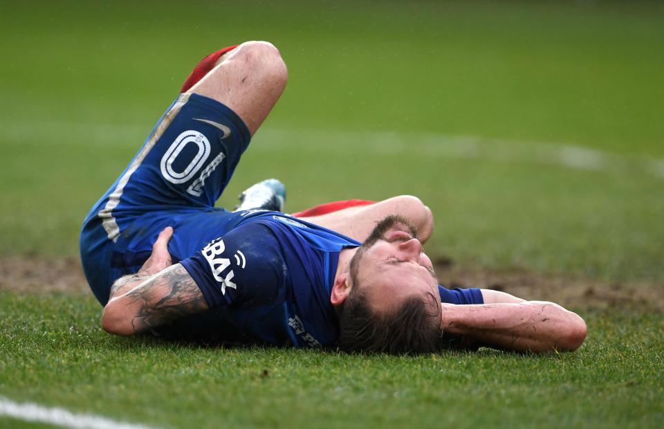  Lloyd writhes on the floor after smacking into the post