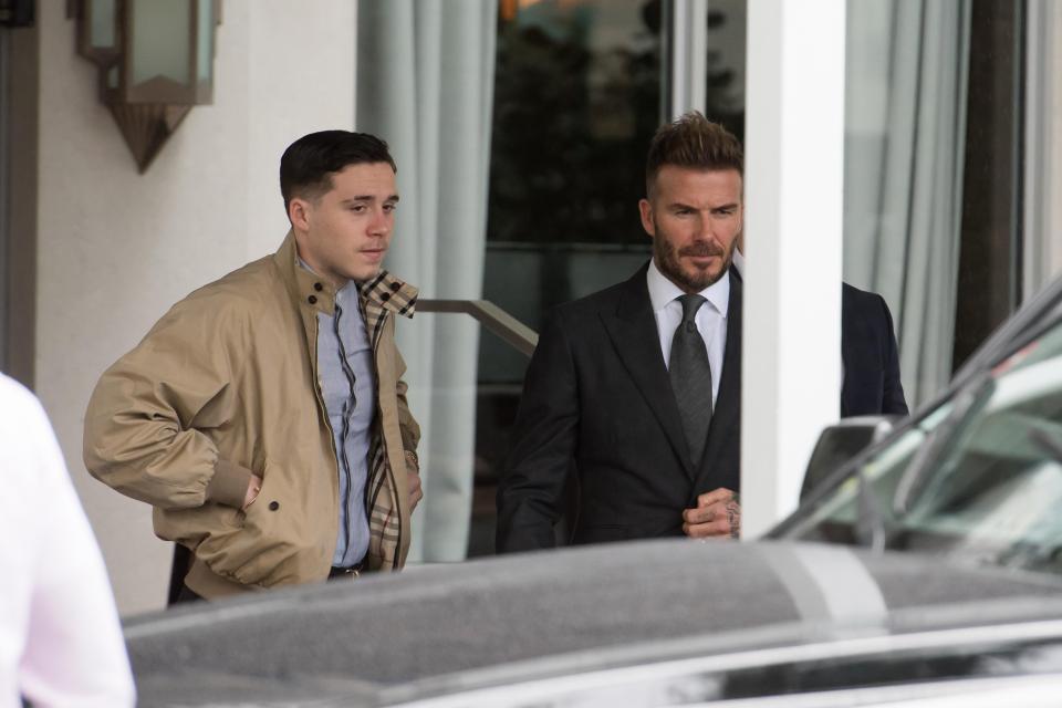 Beckham and his son Brooklyn, 18, leave a Miami hotel just before the announcement