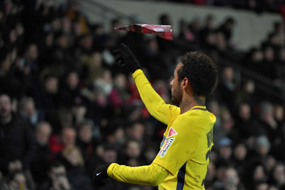  Neymar lobs a paper aeroplane back into the crowd