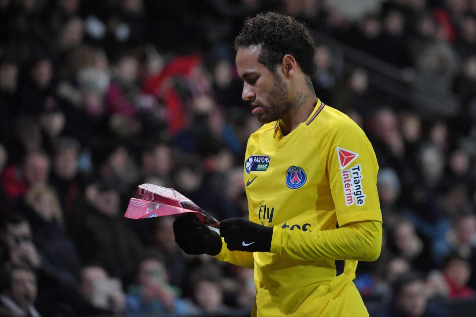 Neymar was not put off as a paper plane hit the pitch