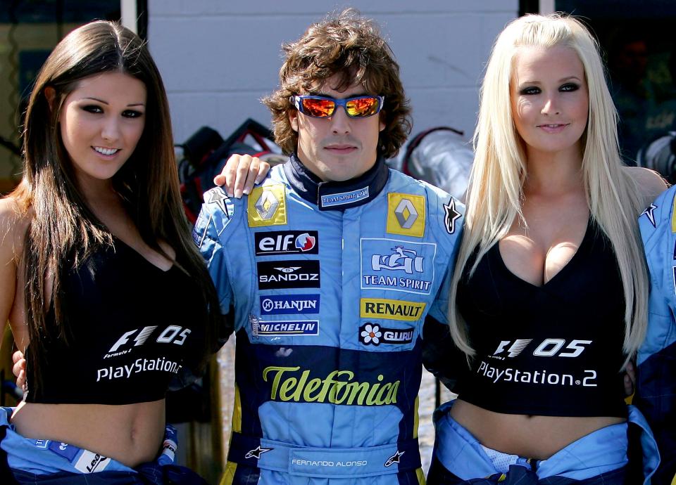  Fernando Alonso strikes a pose at the 2005 British Grand Prix with Michelle Marsh and Lucy Pinder