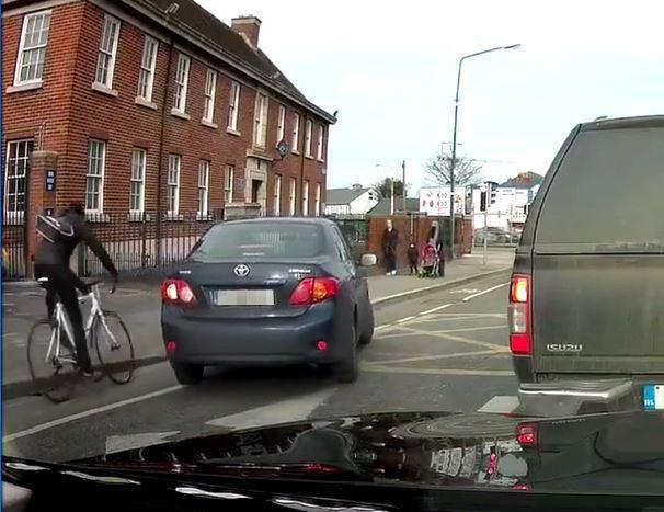 The split second before shows the cyclist driving behind the car