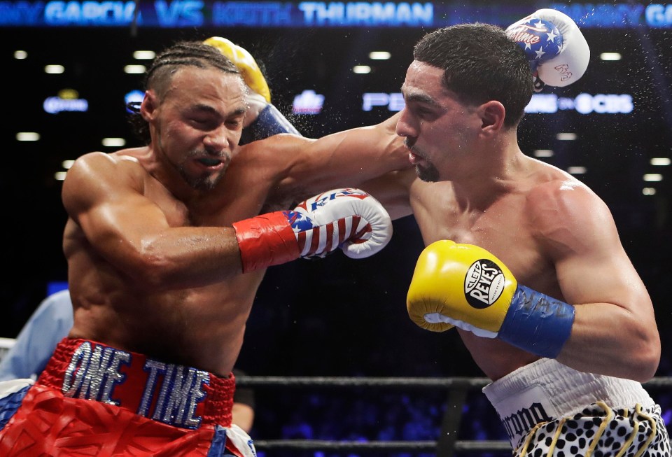 Keith Thurman (left) trades blows with Danny Garcia in his split decision victory