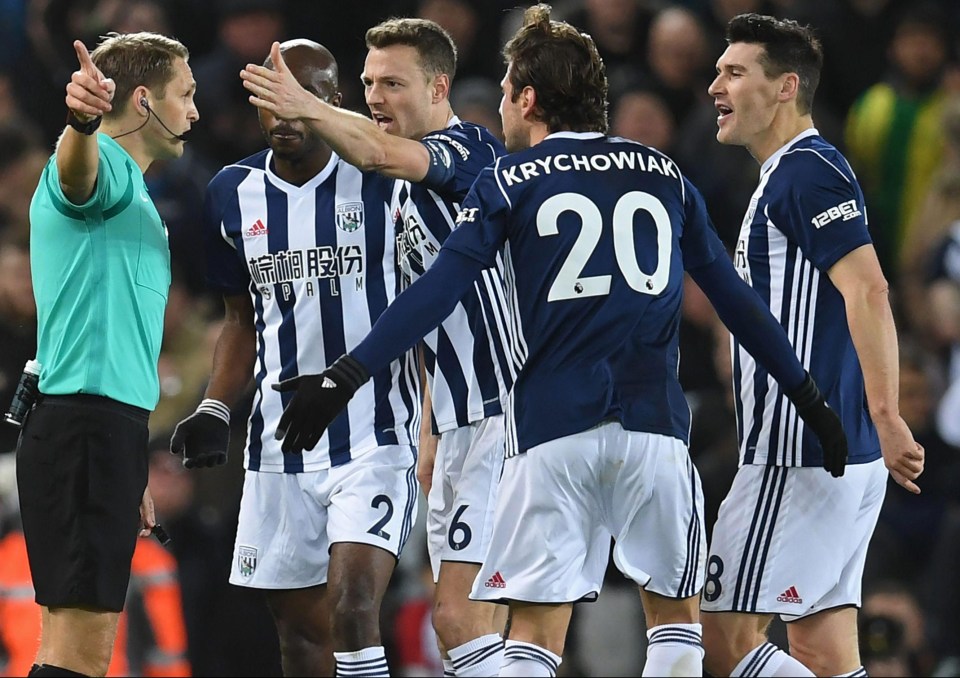 Baggies players surround ref Craig Pawson as he gives Liverpool a penalty after consulting VAR