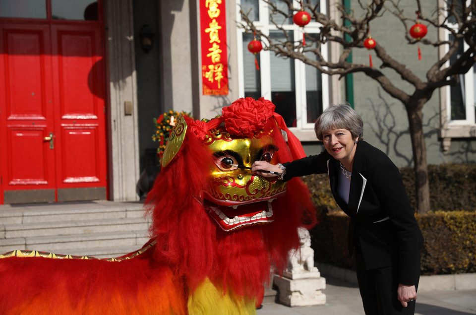  Theresa May dots the eyes of a dragon outside the British Embassy in China