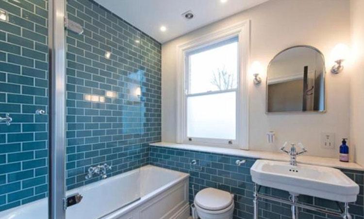 Another bathroom has teal coloured tiles