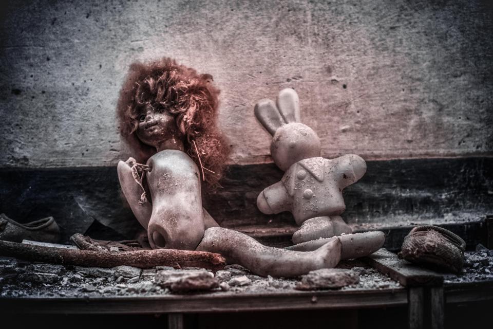 Two children's toys slowly decay in a building in Chernobyl