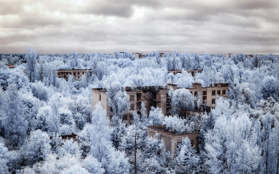 The infrared lens to shoot this pictures makes the abandoned buildings and vehicles all the more striking against the icy backdrop