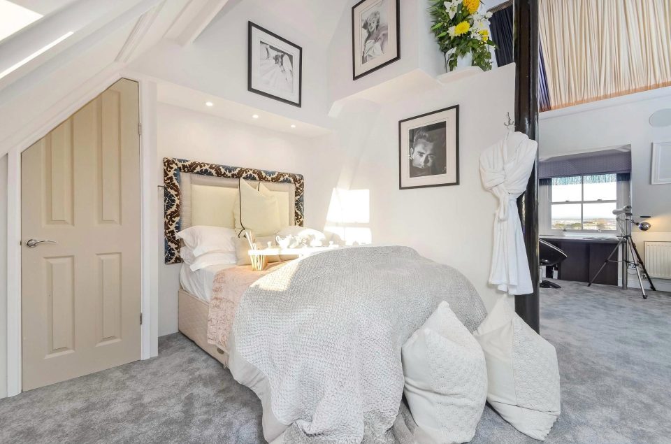  The second-floor bedroom boasts a vaulted ceiling