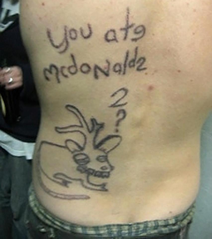 A strange rat-deer hybrid below the messily-written phrase 'you at mcdonaldz' adorns this man's back