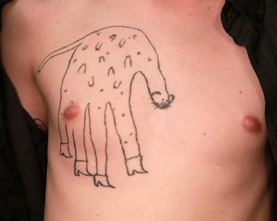 This quirky tattoo-lover turned a hand print into a freakish animal and had it inked over his nipple