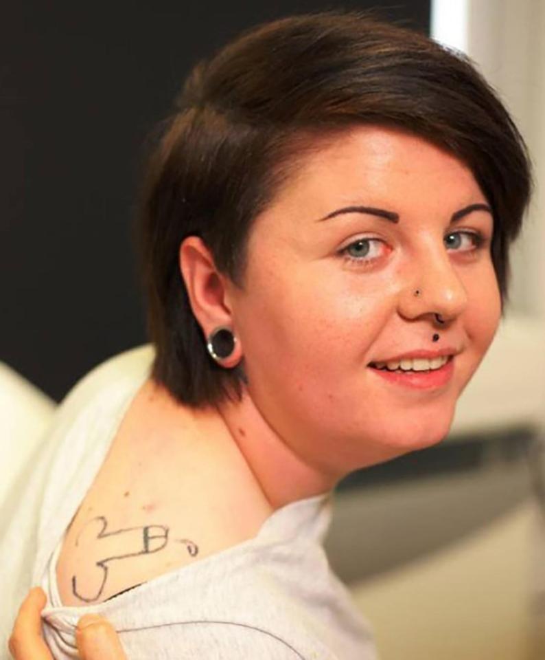 A woman proudly displays the primary school willy she's had emblazoned on her back