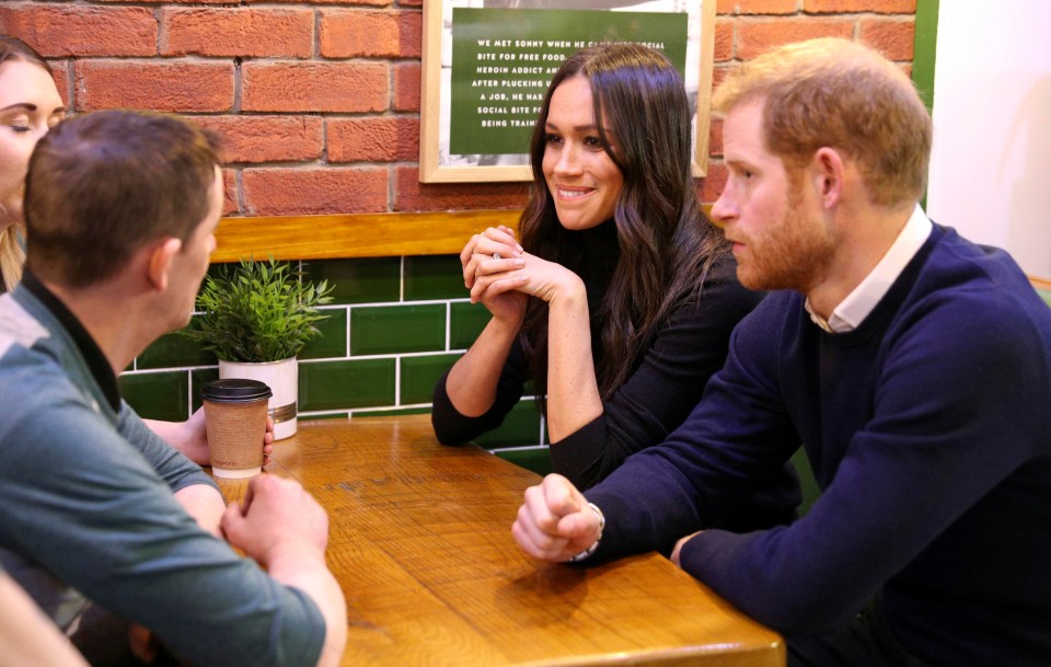 Meghan Markle and Prince Harry speak with patrons at the Social Bite in Edinburgh