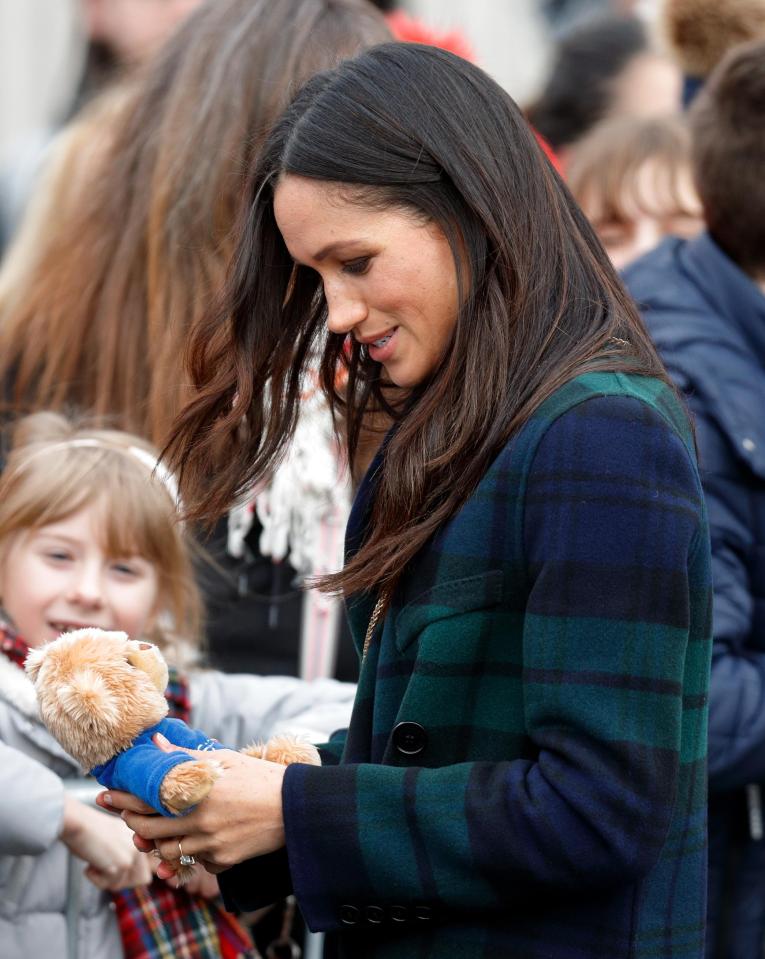  Meghan likes to keep her hands free to accept gifts and shake hands with crowds