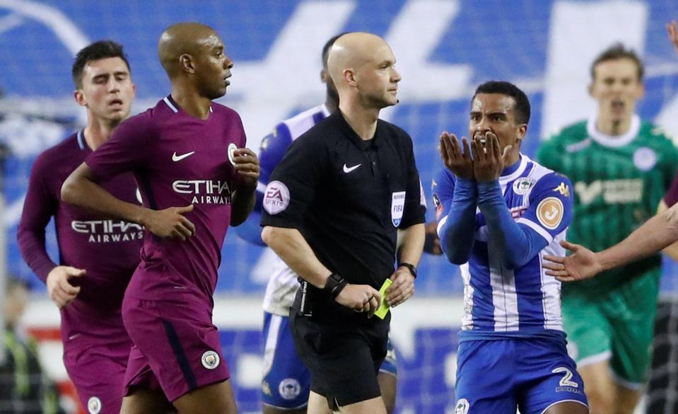  Anthony Taylor came under pressure from the Wigan players and staff following Fabian Delph's challenge