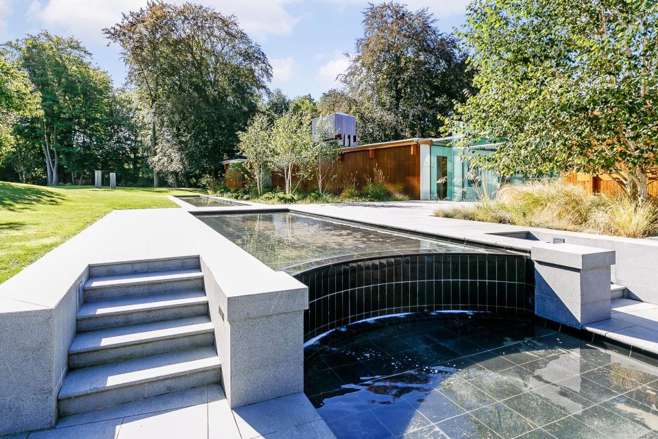  An artistic water feature can be seen at the front of the property