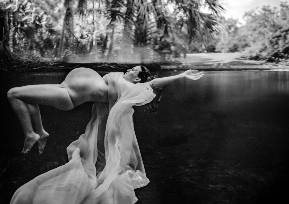 A pregnant mum floats in a lake 