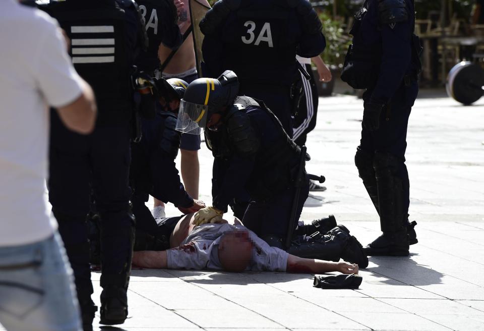  A policemen attending to battered England fan Andrew Bache  in Marseille